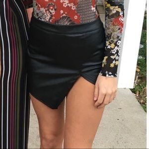 Asymmetrical black leather mini skirt
